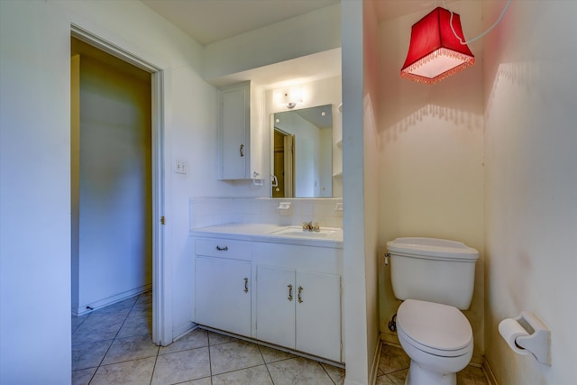 bathroom with tile patterned flooring, toilet, tasteful backsplash, and vanity