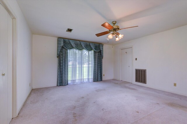 empty room with light carpet and ceiling fan