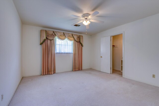 empty room with carpet floors and ceiling fan