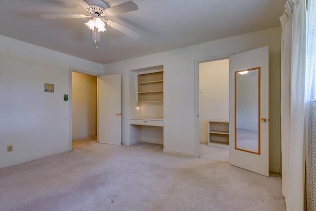 unfurnished bedroom featuring light colored carpet and ceiling fan