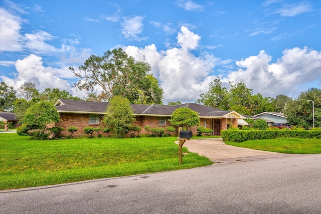 ranch-style home with a front lawn