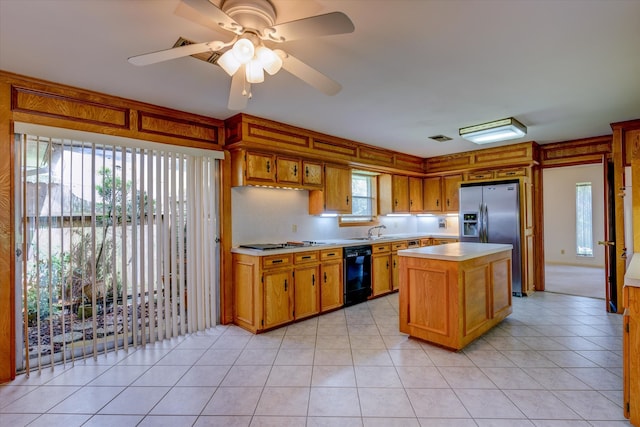 kitchen featuring plenty of natural light, a kitchen island, dishwasher, and ceiling fan