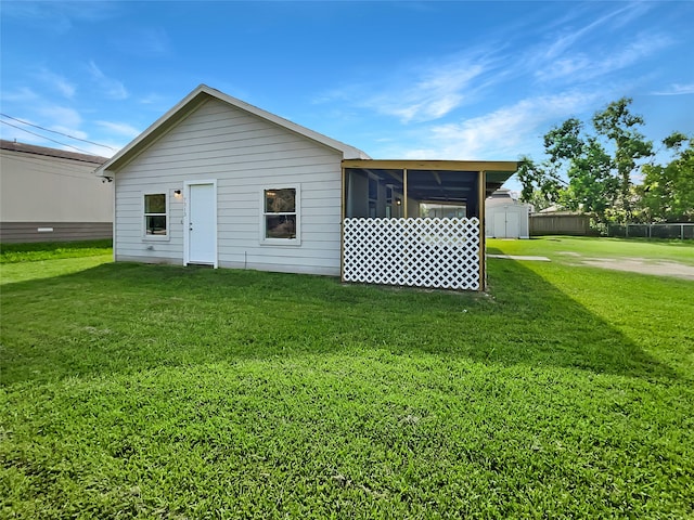 rear view of property with a yard