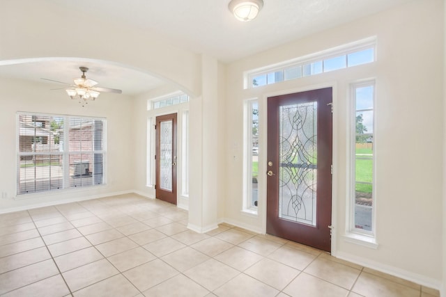 foyer with ceiling fan and light tile patterned floors