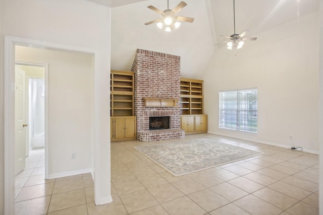 unfurnished living room with light tile patterned floors, a fireplace, high vaulted ceiling, and ceiling fan