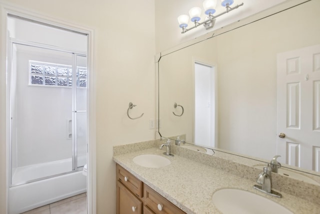 bathroom with enclosed tub / shower combo, vanity, and tile patterned floors