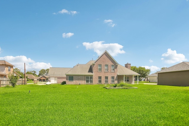 back of house with a lawn