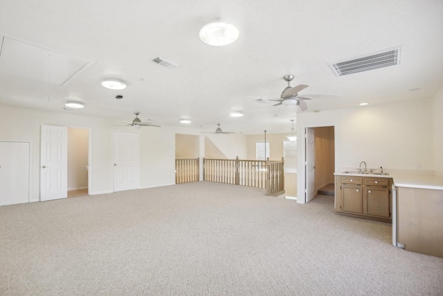 carpeted spare room with sink