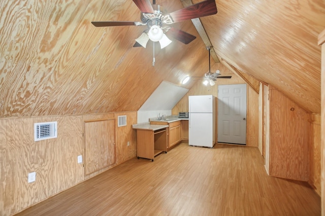 additional living space featuring lofted ceiling, sink, wooden walls, wooden ceiling, and light wood-type flooring