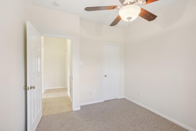 unfurnished bedroom featuring ceiling fan and light carpet