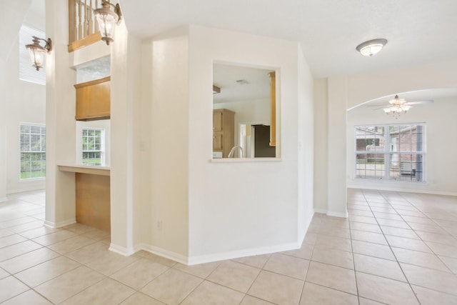 corridor featuring light tile patterned floors