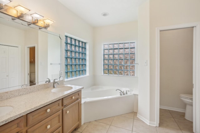 bathroom featuring vanity, tile patterned floors, and toilet