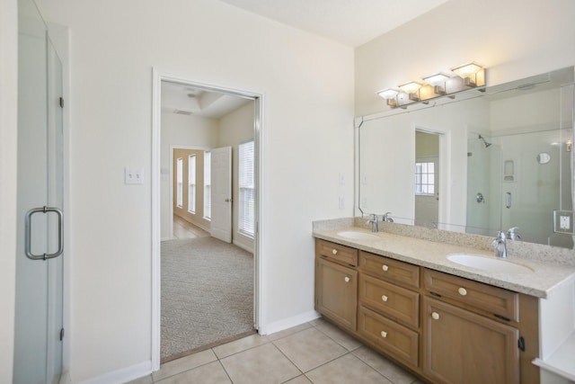 bathroom featuring vanity, a shower with shower door, and tile patterned floors