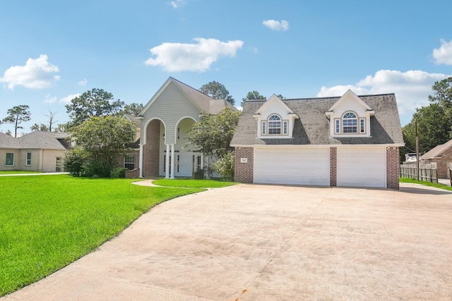 view of front of property with a garage and a front lawn