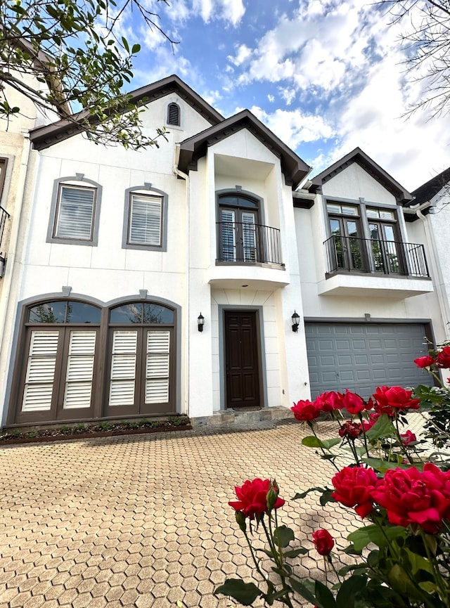 view of front of home with a balcony and a garage