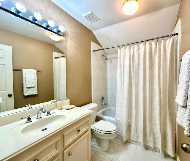 full bathroom featuring shower / tub combo with curtain, lofted ceiling, tile patterned floors, toilet, and vanity