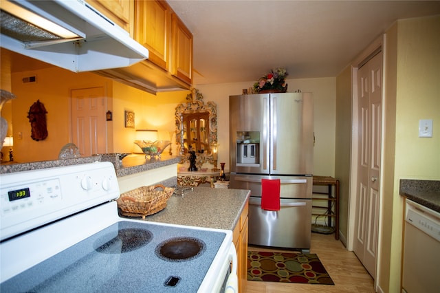 kitchen with range hood, light hardwood / wood-style floors, and white appliances