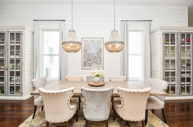 dining room with a healthy amount of sunlight, an inviting chandelier, and hardwood / wood-style floors