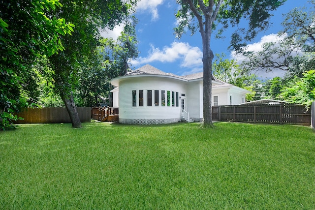 back of house featuring a yard and a deck