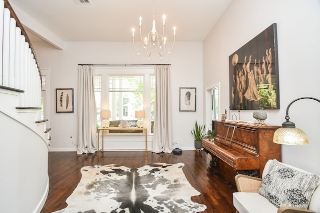 sitting room with an inviting chandelier and dark wood-type flooring