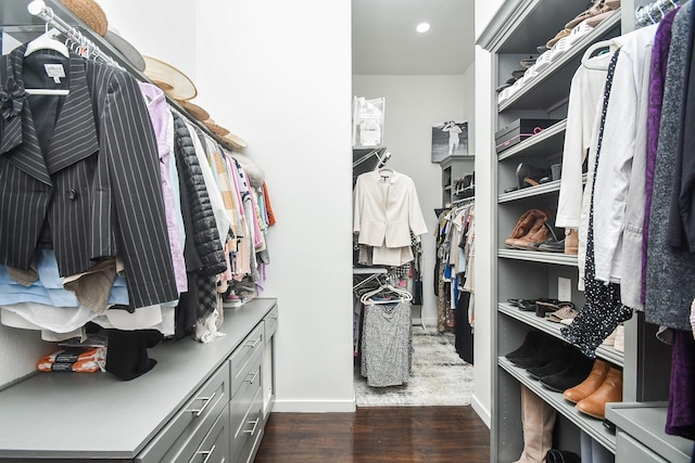 walk in closet with dark hardwood / wood-style flooring