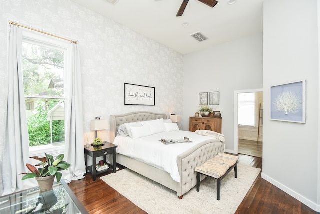 bedroom with dark hardwood / wood-style flooring and ceiling fan