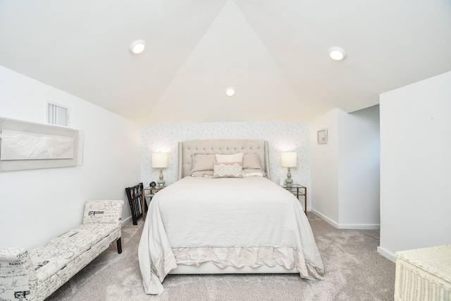 bedroom featuring light carpet and lofted ceiling