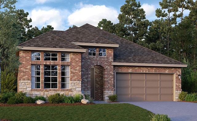 view of front of house featuring a front yard and a garage