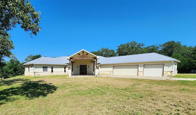 view of front of home featuring a garage and a front lawn