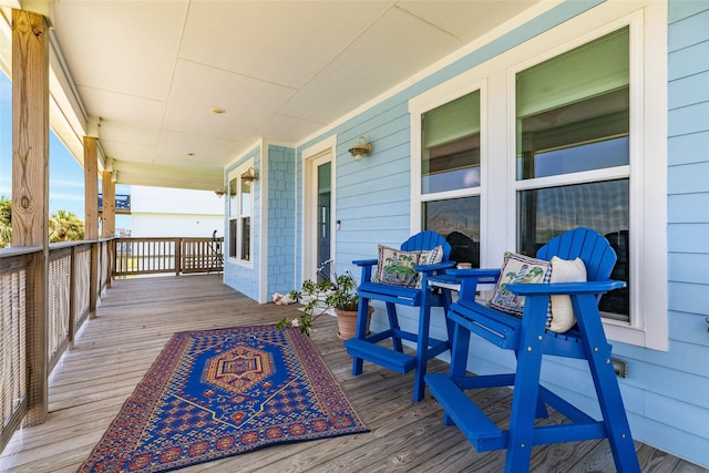 wooden terrace featuring covered porch