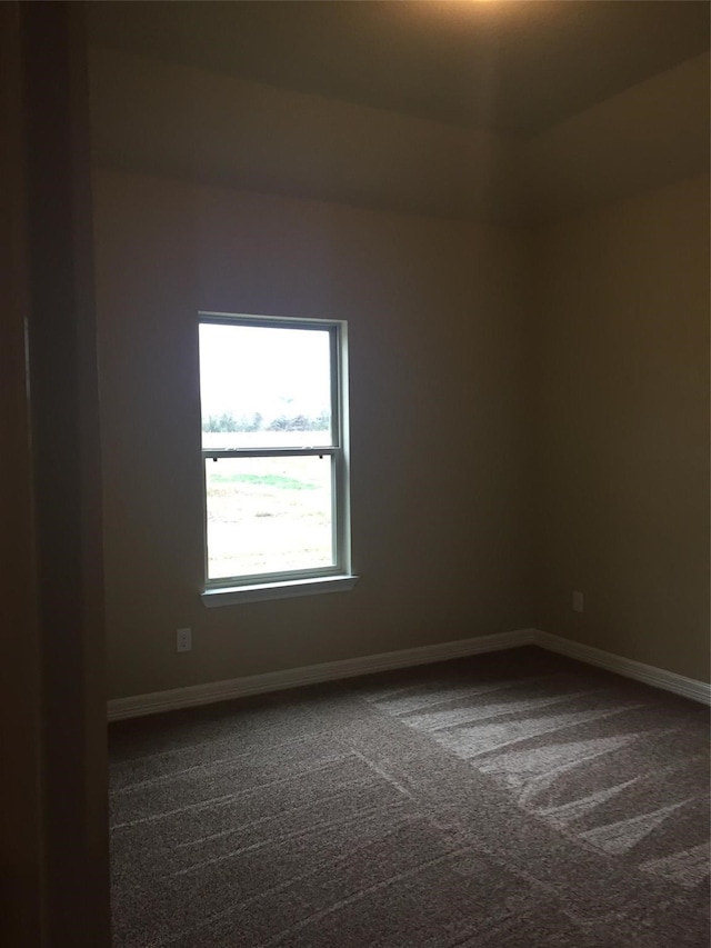 empty room featuring dark colored carpet