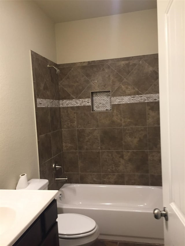 full bathroom featuring toilet, tiled shower / bath combo, and vanity