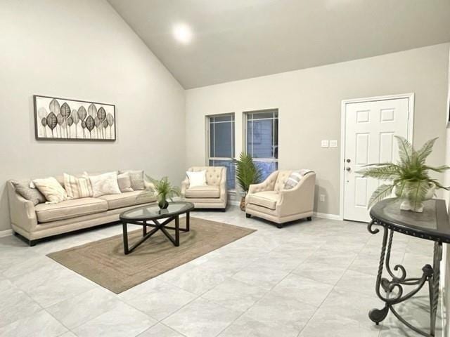 living room featuring high vaulted ceiling