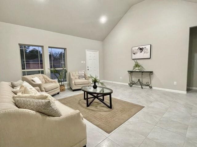 living room with high vaulted ceiling