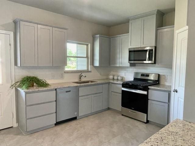 kitchen with sink, gray cabinetry, and stainless steel appliances