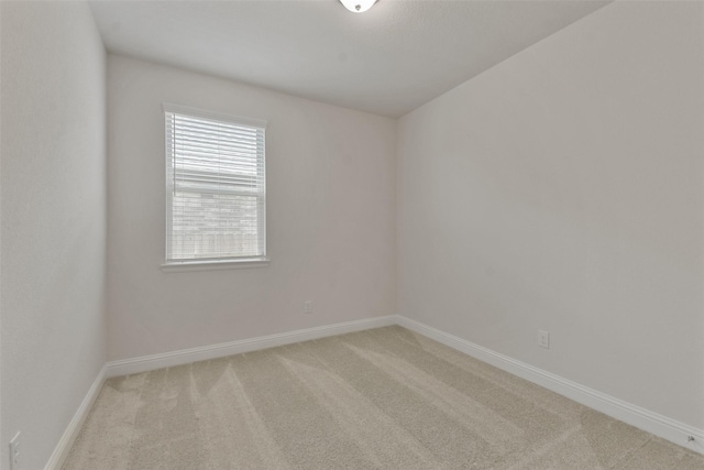 empty room featuring light carpet