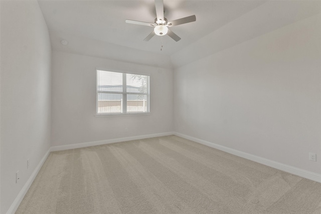 empty room featuring vaulted ceiling, ceiling fan, and carpet flooring