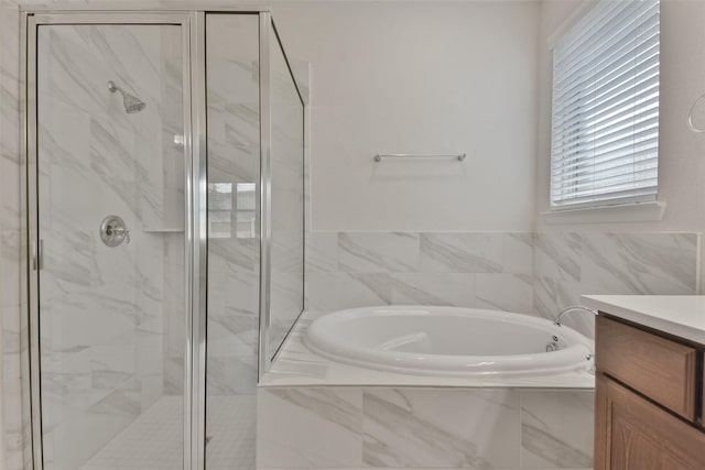 bathroom with vanity and separate shower and tub