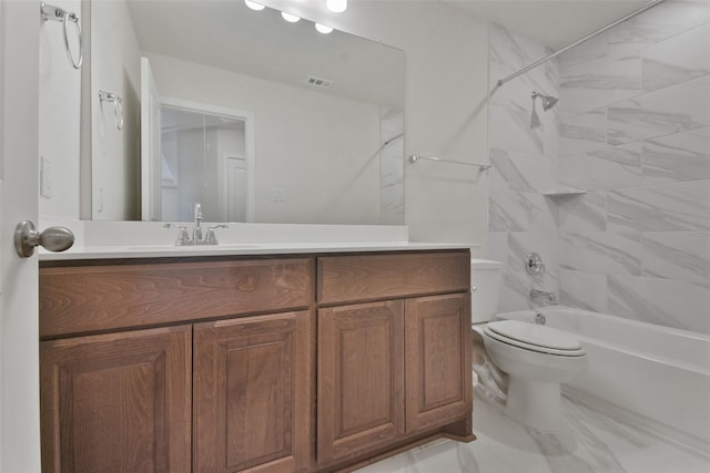 full bathroom with tiled shower / bath, vanity, and toilet