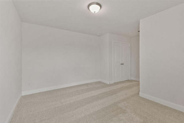 unfurnished room featuring light carpet