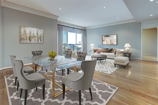 dining room featuring crown molding and light hardwood / wood-style flooring