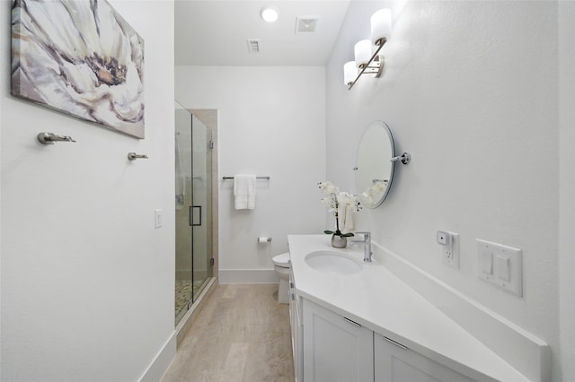 bathroom with walk in shower, wood-type flooring, toilet, and vanity