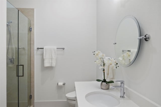 bathroom with vanity, toilet, and an enclosed shower