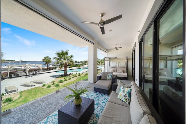 view of patio / terrace with a water view, outdoor lounge area, and ceiling fan