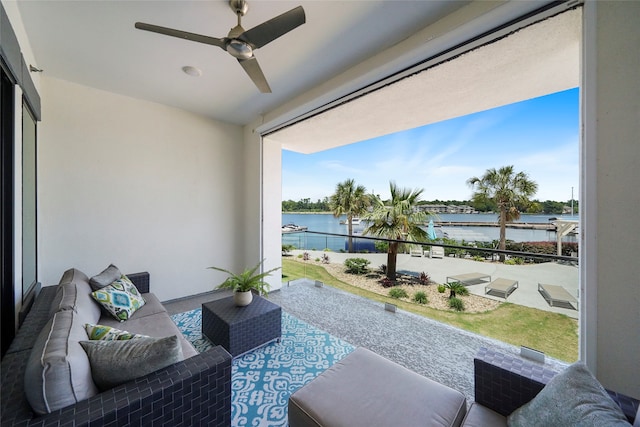 exterior space featuring a healthy amount of sunlight, a water view, and ceiling fan