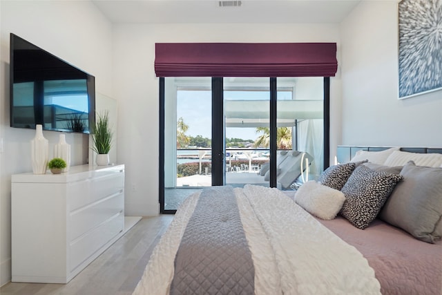 bedroom with access to outside and light hardwood / wood-style flooring