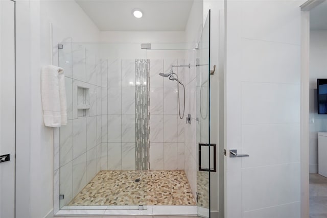 bathroom featuring walk in shower and tile patterned flooring