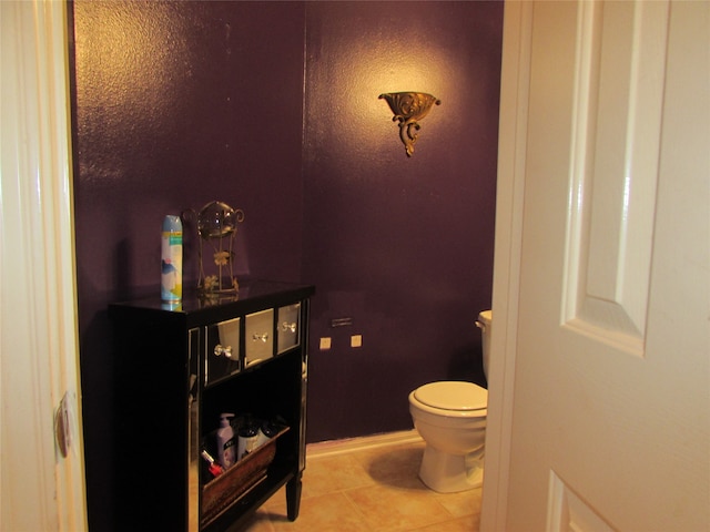 bathroom featuring toilet and tile patterned floors