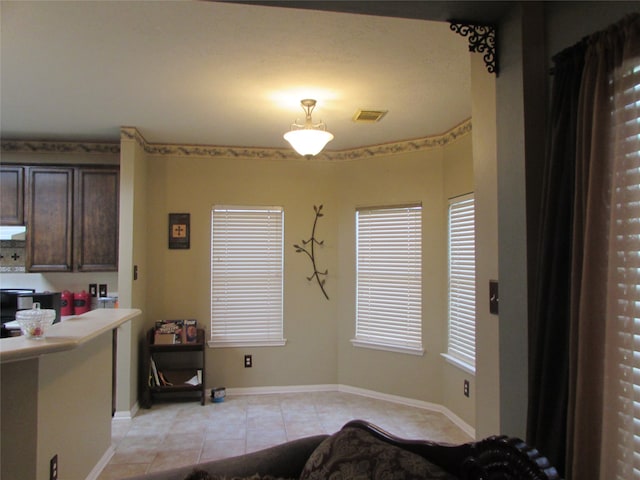 dining area featuring light tile patterned flooring