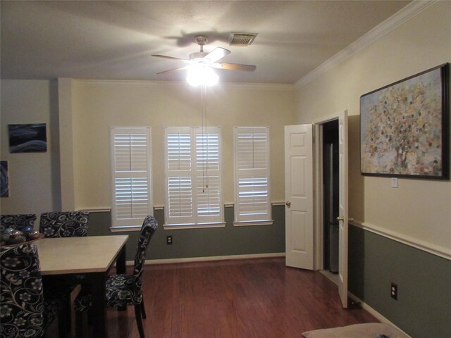 dining area featuring dark wood-type flooring, ornamental molding, and ceiling fan